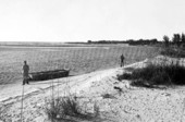 Men anchored at beach - Sanibel Island, Florida.