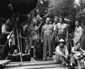 Johnny Weissmuller with MGM crew during filming of Tarzan movie.