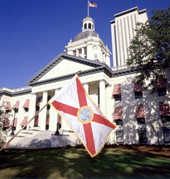 View of Florida's state flag in front of capitol building