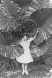 Mary Hays in yard next to large leaves - Tallahassee, Florida.