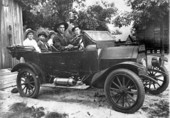 Group of people sitting in an antique car