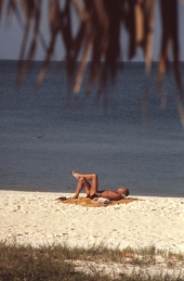 Man in the sun at the beach - Naples, Florida.
