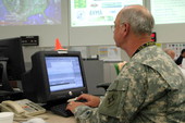 Lieutenant Colonel Pedersen, Florida National Guard, composes an email in the State Emergency Operations Center, Tallahassee during Tropical Storm Ernesto.