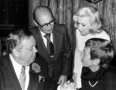 Jackie Gleason, seated at the left, chatting with unidentified people - Fort Lauderdale, Florida.