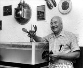 Unidentified man holding lobsters in restaurant - Fort Lauderdale, Florida.