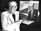 Retired former Miami-Dade Community College Board of Trustee member Mitchell Wolfson posing with his portrait.