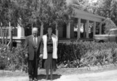 Frank and Jessie Domin standing in front of "state house" living quarters on the Florida State Hospital campus in Chattahoochee, Florida.