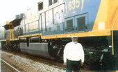 Portrait of Ralph Roberts, the first African American train engineer from Baldwin, Florida standing by locomotive