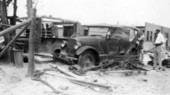 View showing damaged car and debris left by the 1928 hurricane - Palm Beach, Florida.