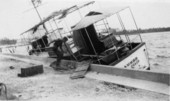 View showing a boat on Lake Worth damaged by the hurricane of 1928 - West Palm Beach, Florida.
