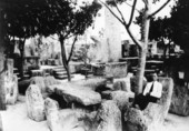 Ed Leedskalnin sitting in a chair at his Rock Gate Park in Florida City, Florida.