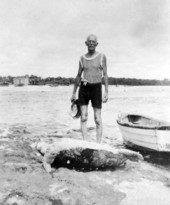 Unidentified man with a sea turtle he caught in the Florida Everglades.