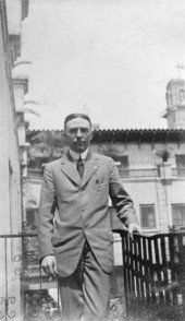 Portrait of Fred C. Aiken from Chicago on a balcony at the Ponce de Leon hotel in Saint Augustine, Florida.