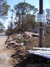 Debris piles in front of houses in Pensacola, Florida.