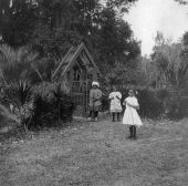 African American girls standing by gate to St. Margaret's Episcopal Church in Hibernia.