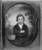 Portrait of Richard Call Long sitting with arms folded.