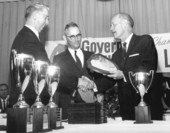 Florida Governor Farris Bryant handing out a Governor's award plaque.