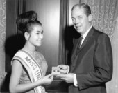 Florida Governor Haydon Burns exchanging a gift with Miss Universe.