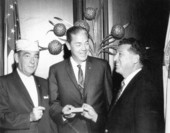Florida Governor Haydon Burns passing a card to a United States war veteran.