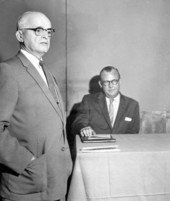 Legislator Jack Mathews, seated, with unidentified man.
