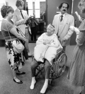 Parents and wheelchair bound daughter talking to reporters