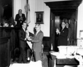 Jerry Thomas presenting owl to colleague.