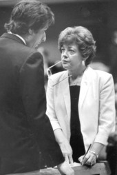 Representative takes notes as she listens to the comments of the other.