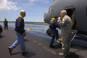 Governor Charlie Crist, left, boarding U.S. Air Force turboprop airplane during Tropical Storm Fay.