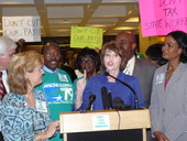 State Representative Marti Coley speaking at the state capitol during a news conference to protest the state budget proposal seeking to reduce state employee salaries.