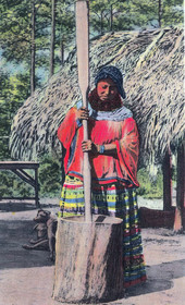 Seminole Indian woman grinding corn in the Florida Everglades.