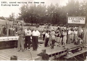 Crowd waiting for deep sea fishing boats..
