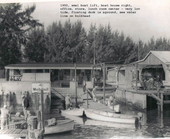 View of small boat rental dock, with lift and boat house to the right, at Layton's Park - Riviera Beach, Florida.