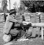 Man hewing shingles
