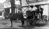 Firemen on the first hose wagon by the station - Tallahassee, Florida.