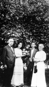 Family beside grapefruit tree