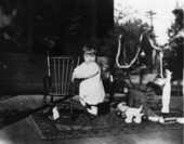 Child with christmas tree and toys