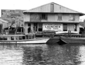 Building advertising launches for hire at the Bayen street dock - Pensacola, Florida.