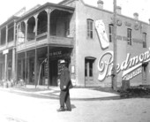 Man walking in the street in front of building - Pensacola, Florida.