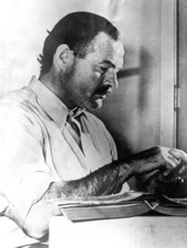 Ernest Hemingway working at his desk