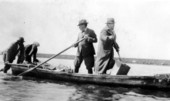 Men poling out to hunting retreat - Piney Island, Florida