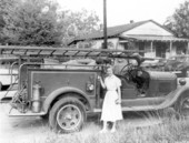 Girl standing in front of a fire truck - Havana, Florida.