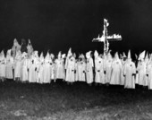 Ku Klux Klan members gathered in front of a burning cross - Tallahassee, Florida.