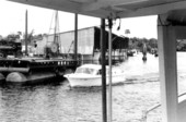 Boat traveling on the Saint Marks River near boathouse - Saint Marks, Florida