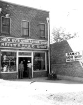 Men standing in entranceway to stores - Tallahassee, Florida.