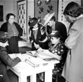Blind woman reading braille while women watch - DeFuniak Springs, Florida
