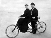 Couple, with a bicycle built for two, at the beach - Daytona Beach, Florida