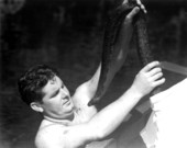 Ross Allen, of Silver Springs, holding a rattlesnake that he captured at Wakulla Springs