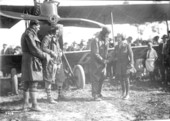 Mabel Cody and three aviators from her "Flying Circus" in front of a biplane in Coral Gables.