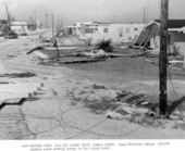 Looking south along Key Colony Drive at damage to Key Colony Hotel