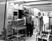 Technicians conducting final test on a telemetry ground station for NASA